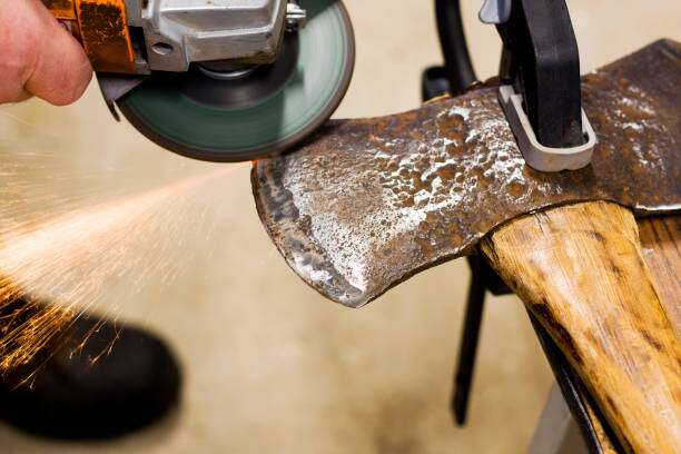Using an angle grinder to sharpen an axe blade